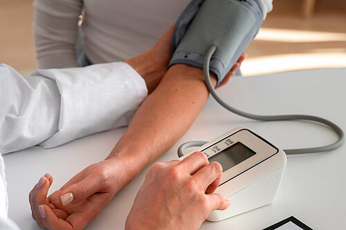 A patient having their blood pressure taken