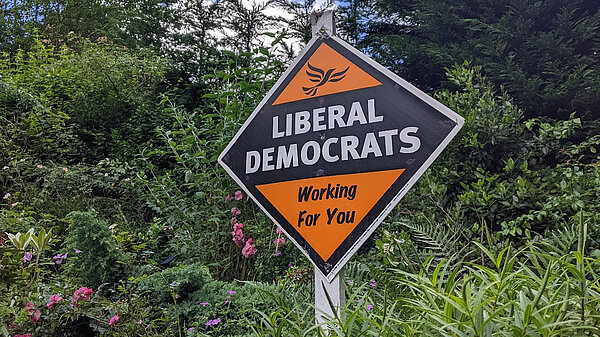 Liberal Democrats: Working For You poster in a garden