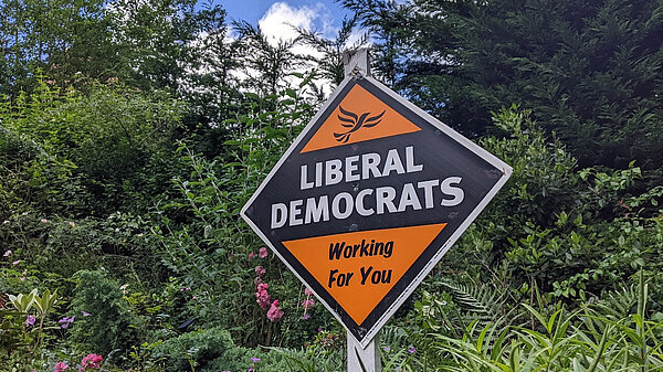 Liberal Democrats: Working For You poster in a garden