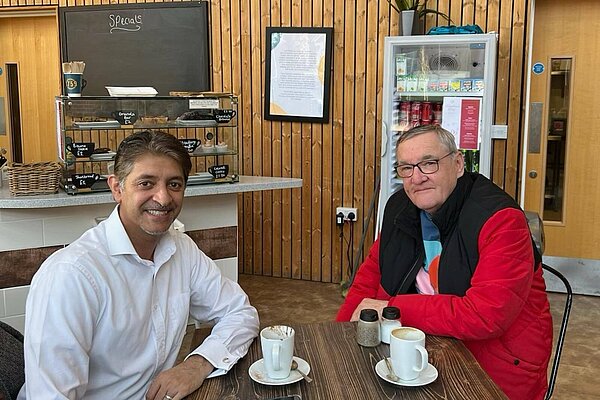 Khalil Yousuf meeting a local resident over coffee